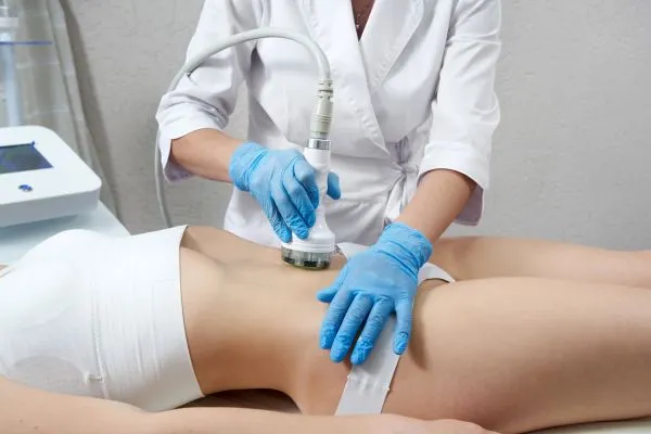 Lost the Weight but Not the Loose Skin? 2 woman having HIFU treatment on her stomach to combat loose skin Redbourn following weight loss